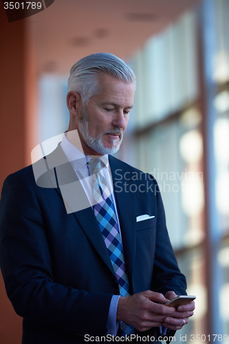 Image of senior business man talk on mobile phone