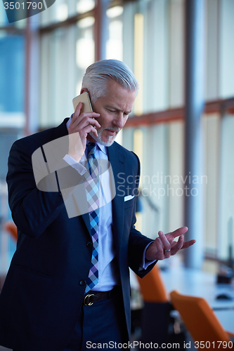 Image of senior business man talk on mobile phone