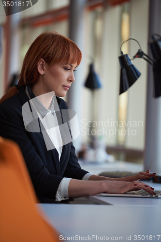 Image of business woman working on computer at office