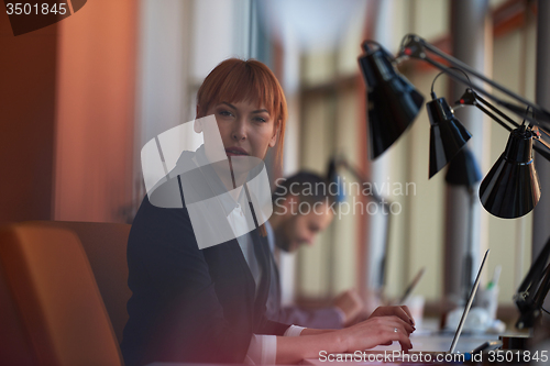 Image of business woman working on computer at office