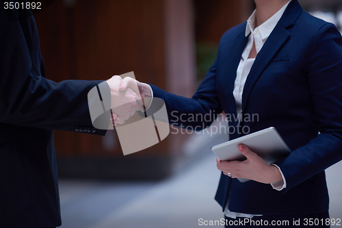 Image of business man and woman hand shake