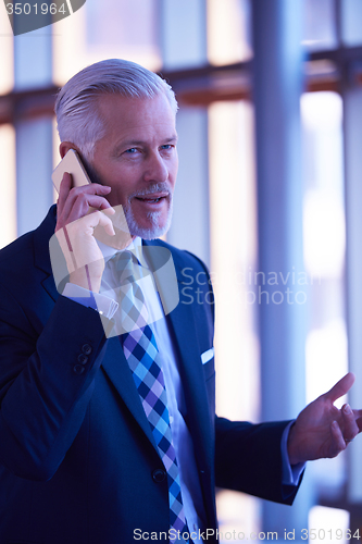 Image of senior business man talk on mobile phone