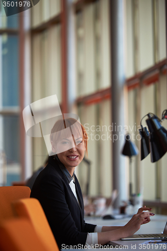 Image of business woman working on computer at office