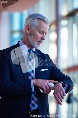 Image of senior business man talk on mobile phone