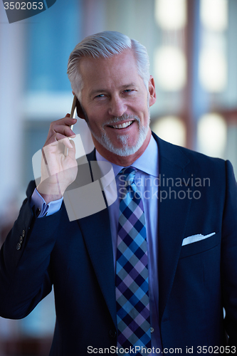 Image of senior business man talk on mobile phone