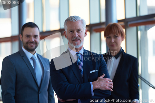Image of senior business man with his team at office