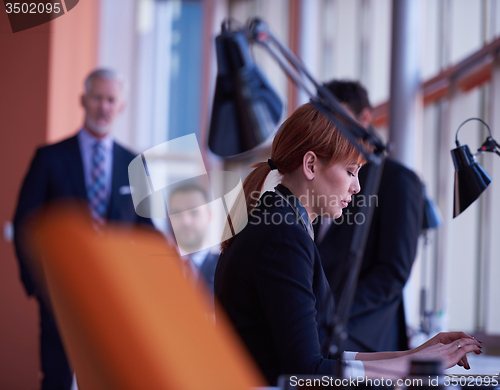Image of business woman working on computer at office