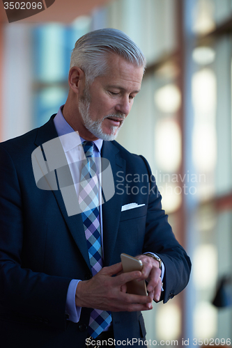 Image of senior business man talk on mobile phone