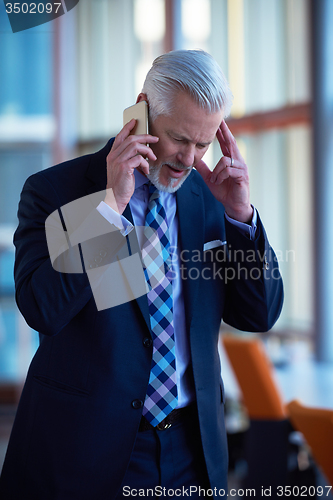 Image of senior business man talk on mobile phone