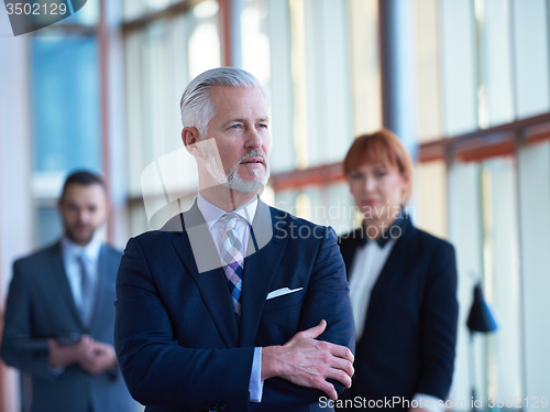 Image of senior business man with his team at office