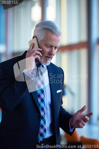 Image of senior business man talk on mobile phone