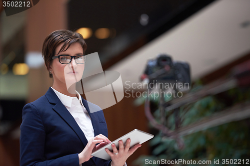 Image of business woman working on tablet