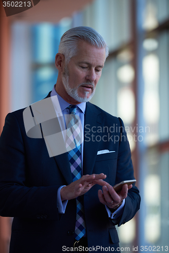 Image of senior business man talk on mobile phone
