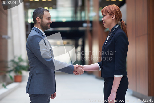 Image of business man and woman hand shake