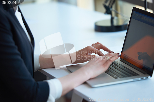 Image of business woman working on computer at office