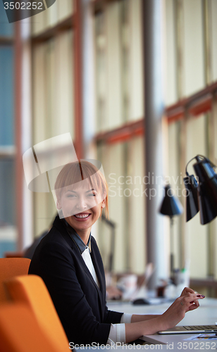 Image of business woman working on computer at office