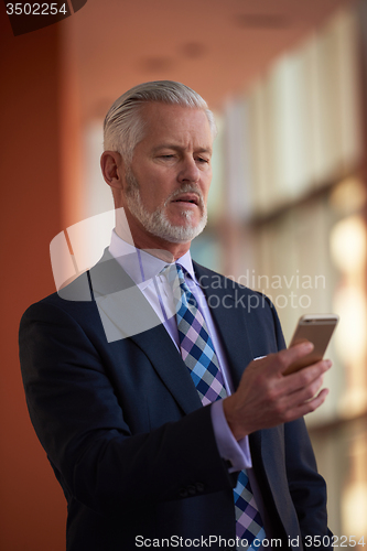 Image of senior business man talk on mobile phone