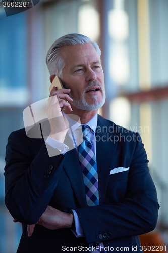 Image of senior business man talk on mobile phone