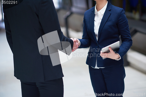 Image of business man and woman hand shake