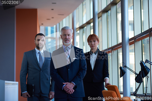 Image of senior business man with his team at office