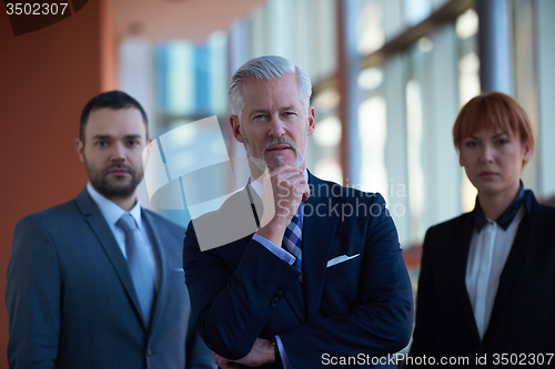 Image of senior business man with his team at office