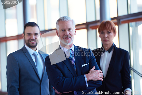 Image of senior business man with his team at office