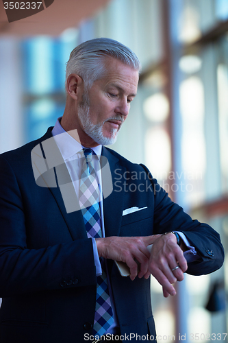 Image of senior business man talk on mobile phone