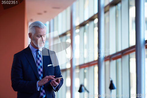 Image of senior business man talk on mobile phone