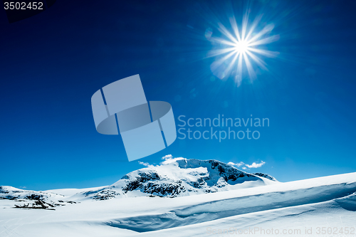Image of Sun and snowy mountain.