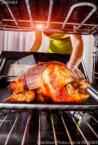 Image of Cooking chicken in the oven at home.