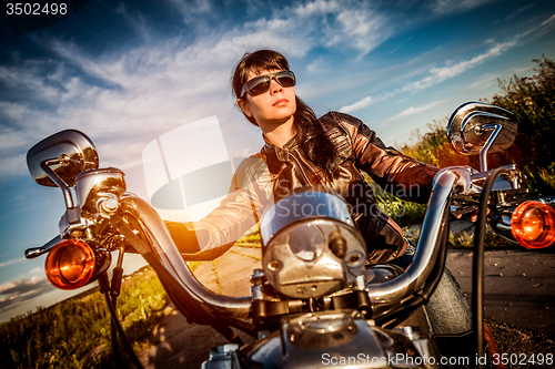 Image of Biker girl on a motorcycle