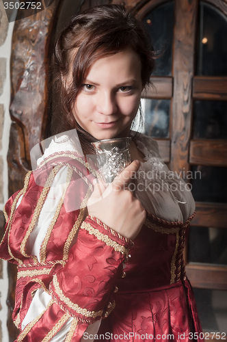 Image of Attractive woman in red dress in retro baroque style