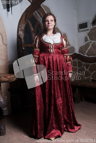 Image of Attractive woman in red dress in retro baroque style