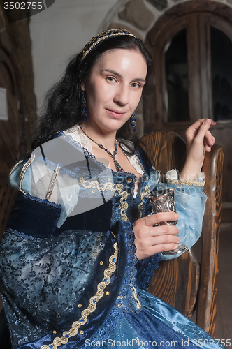 Image of Attractive woman in red dress in retro baroque style