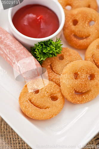 Image of sausages with smiling potatoes