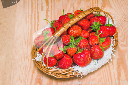 Image of Basket of strawberries on the table surface.