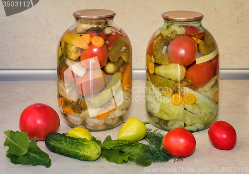 Image of  A variety of canned vegetables in glass jars.