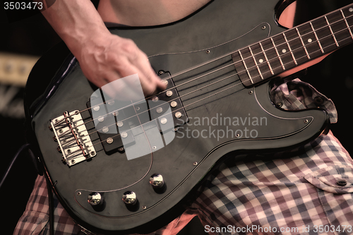 Image of A musician playing electric guitar on concert