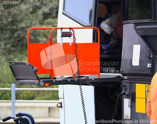 Image of details of a bus using a chair lift for wheelchair