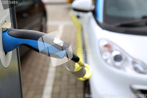 Image of Electric car being charged at the station, close up of the power