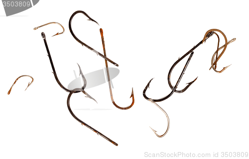 Image of Rusty old fishhooks on white background