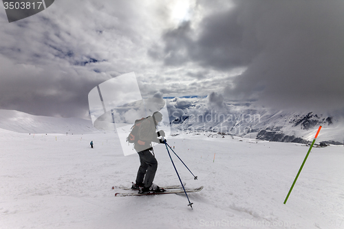 Image of Skier on ski slope before storm