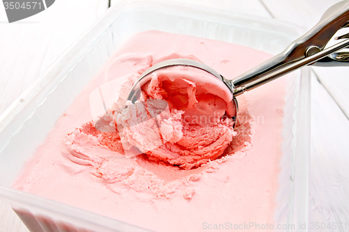 Image of Ice cream strawberry in scoop and tray on board