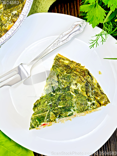 Image of Pie celtic with spinach in plate on table top