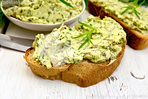 Image of Sandwich with butter of spinach and cucumber on light board