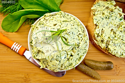 Image of Butter with spinach and herbs in bowl on board top