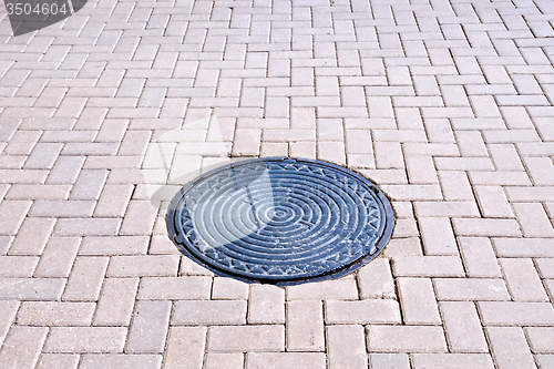 Image of Pavement of tiles with a hatch