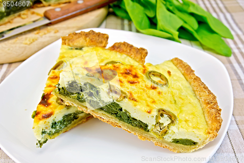 Image of Pie with spinach in plate on fabric