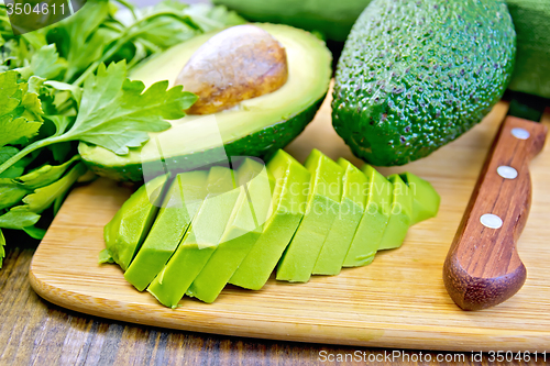 Image of Avocado slices on board with knife