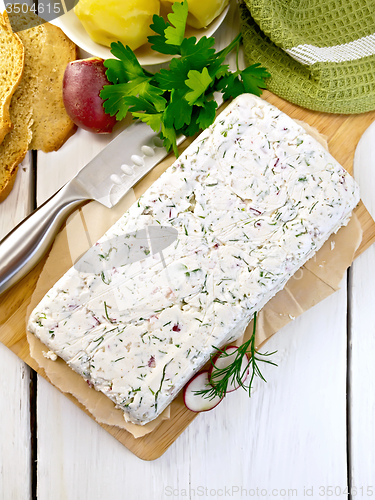 Image of Terrine whole of curd and radish on paper and board top